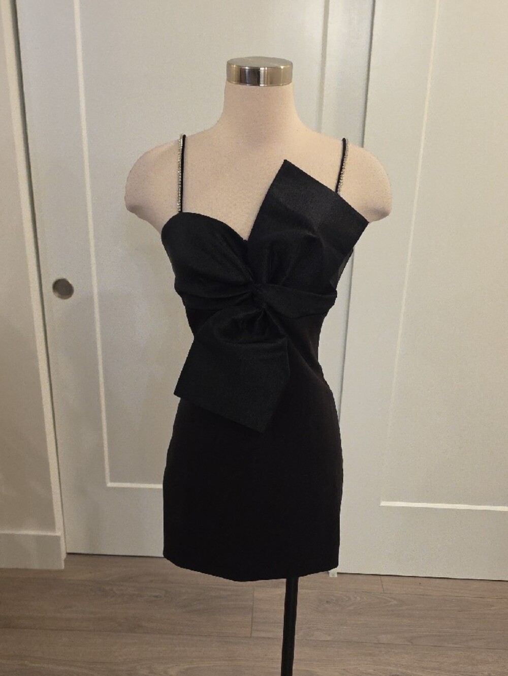 Likely women’s Black Mini Dress with Statement Bow and rhinestone straps size 6